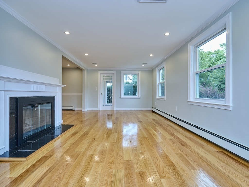 33 Theodore Road Newton, MA 02459 - Photo 4 of 42 a view of an empty room with a fireplace and a window