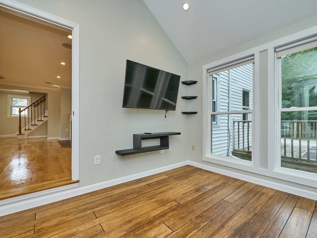33 Theodore Road Newton, MA 02459 - Photo 6 of 42 a view of a livingroom with wooden floor and a flat screen tv
