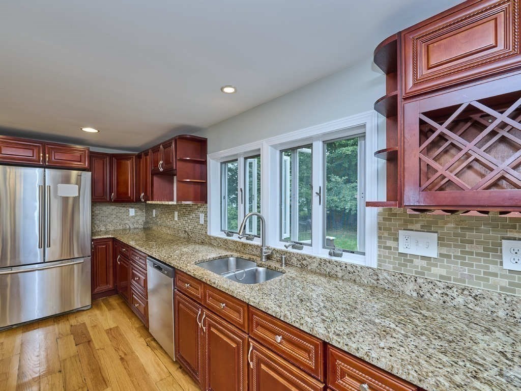 33 Theodore Road Newton, MA 02459 - Photo 8 of 42 a kitchen with stainless steel appliances granite countertop a sink a stove and a refrigerator