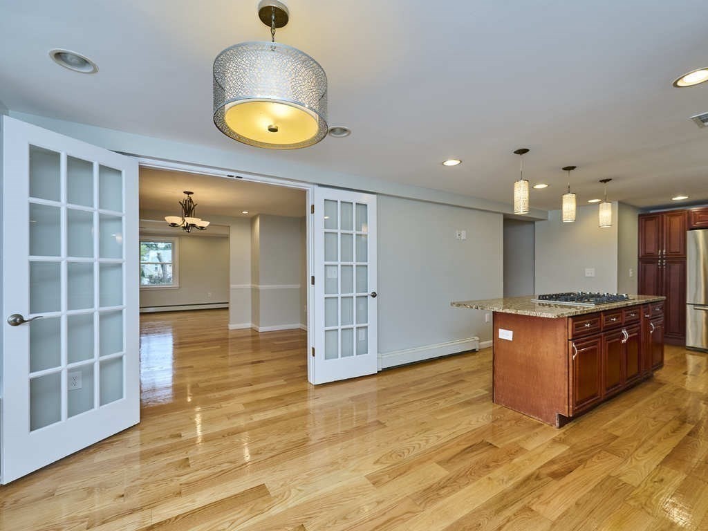 33 Theodore Road Newton, MA 02459 - Photo 9 of 42 a view of an empty room with wooden floor and a window