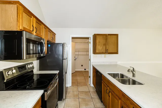 a kitchen with stainless steel appliances a sink stove and cabinets