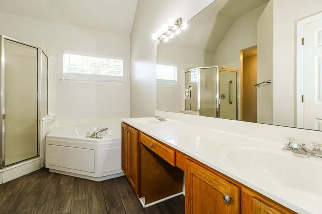 a bathroom with a tub sink and a mirror
