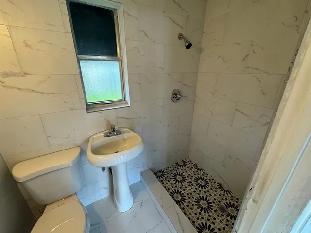 a bathroom with a sink toilet and a mirror