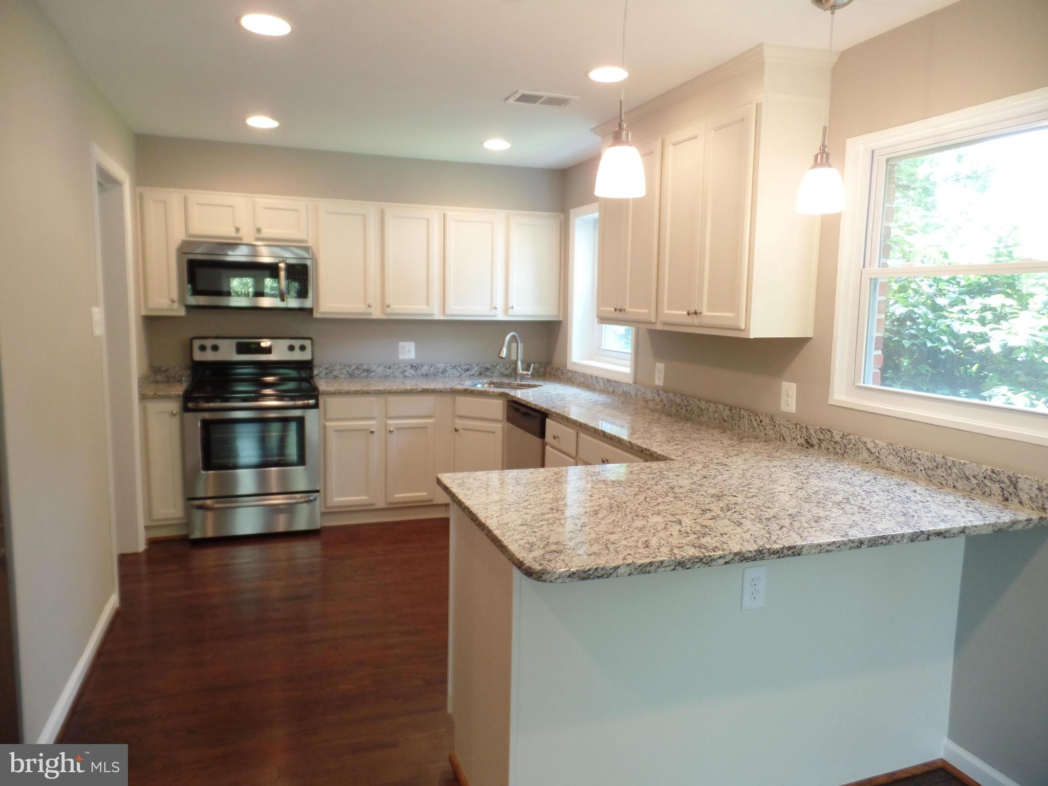 2822 Denley Place Silver Spring, MD 20906 - Photo 5 of 18 a kitchen with stainless steel appliances granite countertop a sink stove and refrigerator