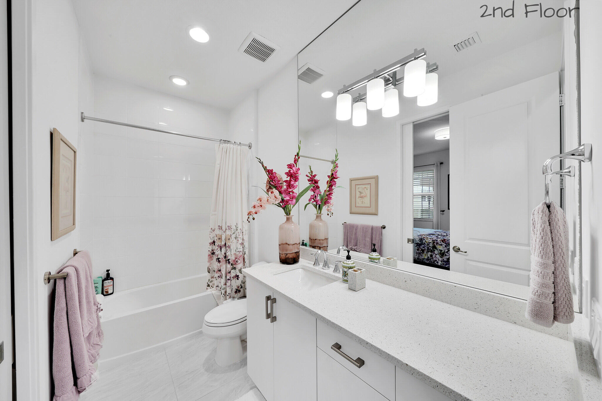 4821 Pointe Midtown Road Palm Beach Gardens, FL 33418 - Photo 21 of 62 a bathroom with a sink a toilet and a large mirror