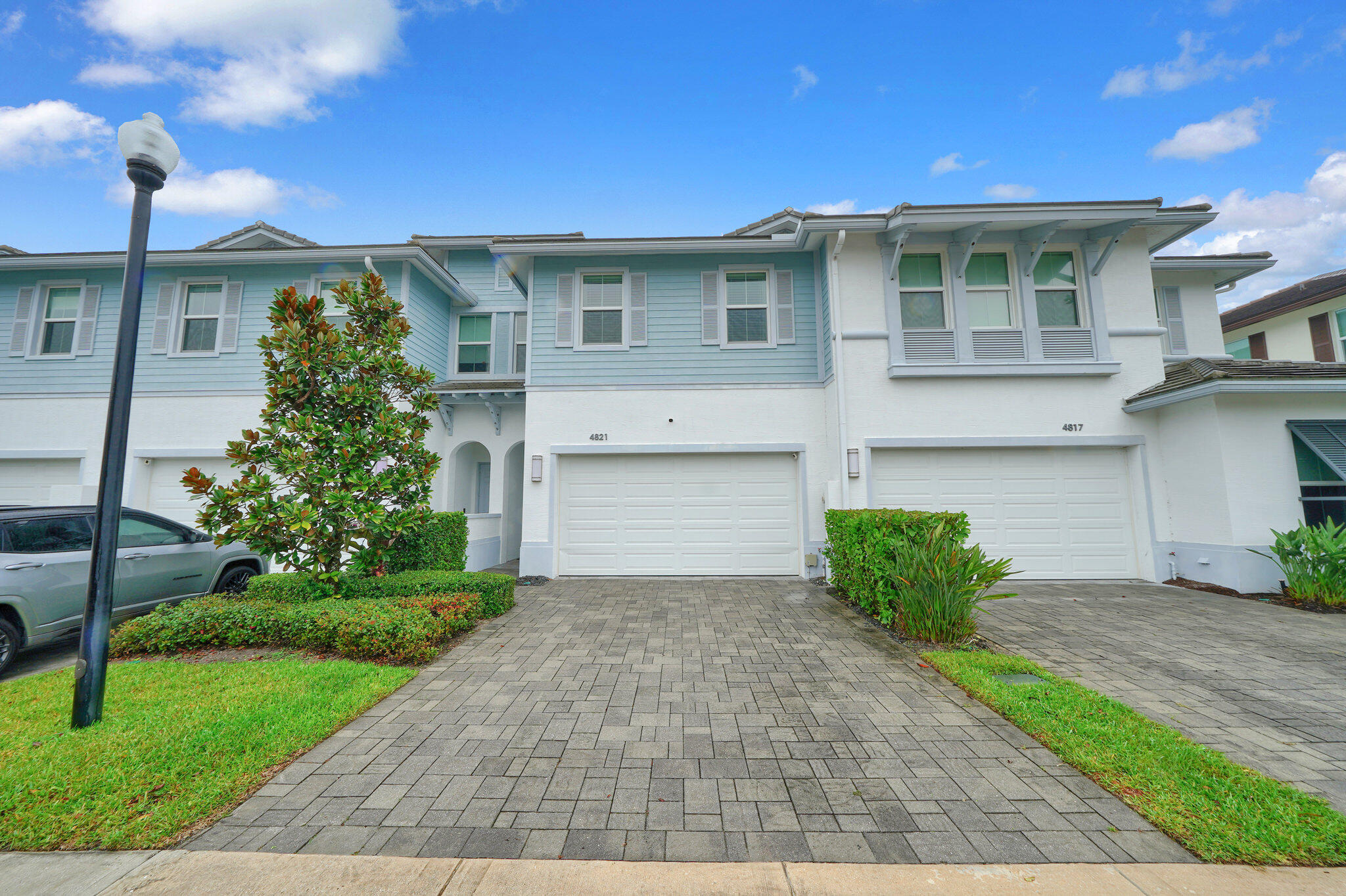 4821 Pointe Midtown Road Palm Beach Gardens, FL 33418 - Photo 62 of 62 a front view of a house with a yard and garage