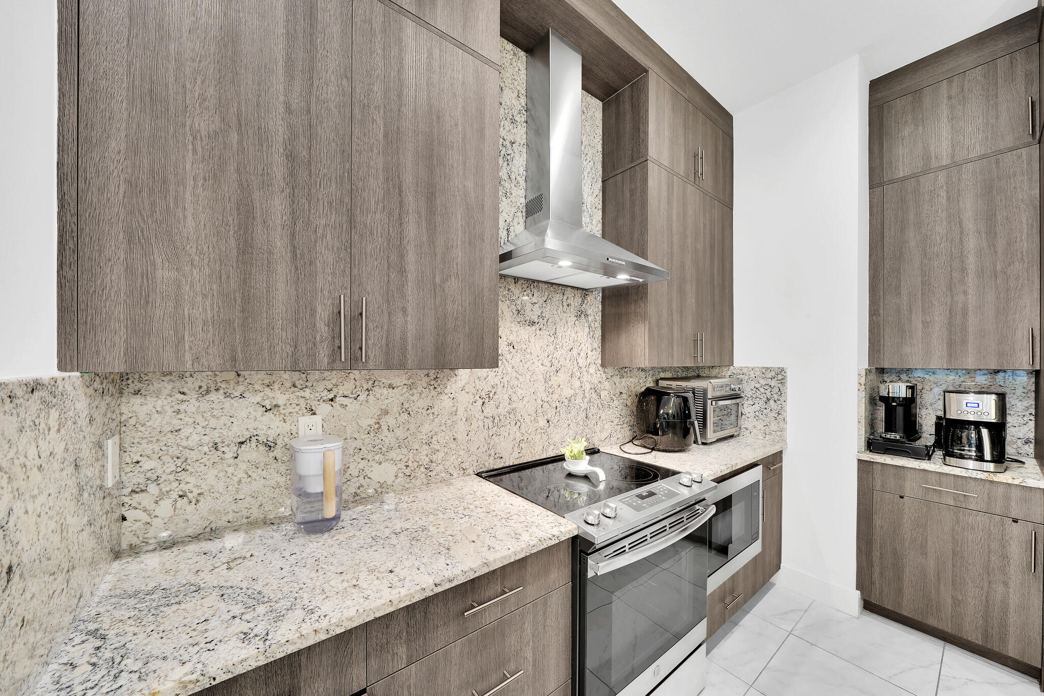 4821 Pointe Midtown Road Palm Beach Gardens, FL 33418 - Photo 9 of 62 a kitchen with granite countertop a sink a stove and cabinets