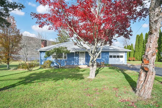 a view of a house with a yard