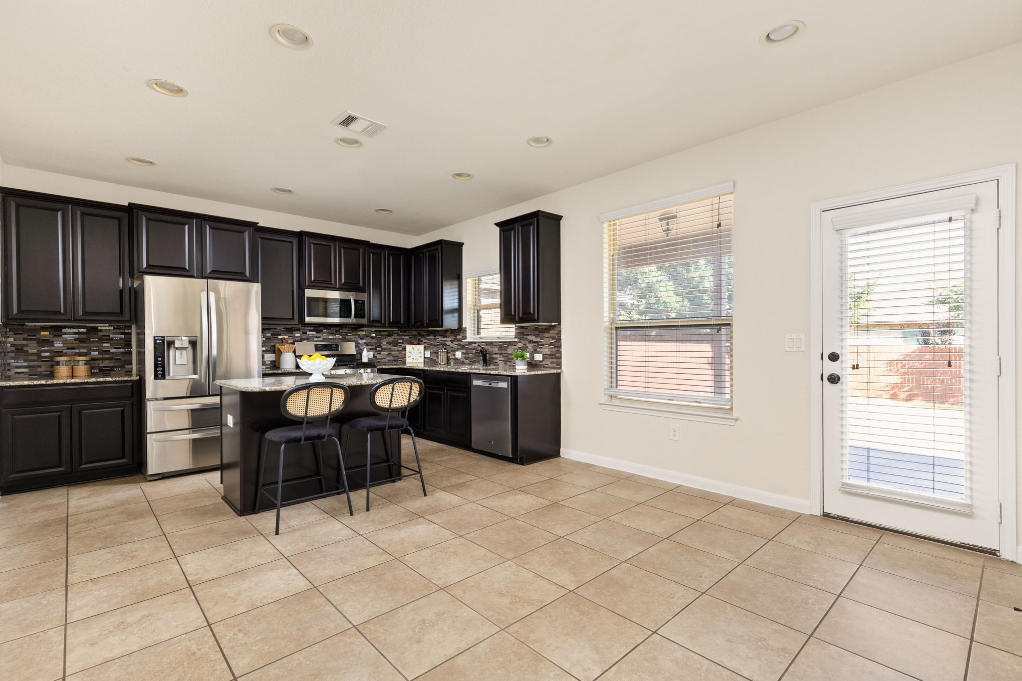 2400 Leonards Pass Leander, TX 78641 - Photo 14 of 40 Culinary delights await in this contemporary kitchen, featuring an island and stainless steel appliances.