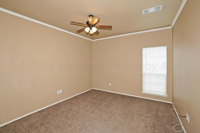 a view of an empty room with a ceiling fan