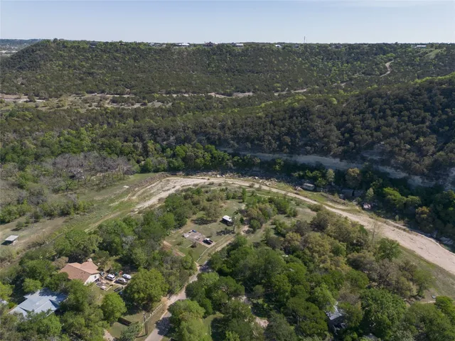 an aerial view of residential house with green space