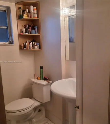 a bathroom with a toilet a sink and a shower