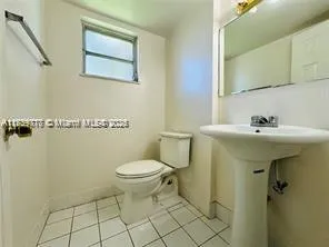 a bathroom with a sink toilet and a mirror