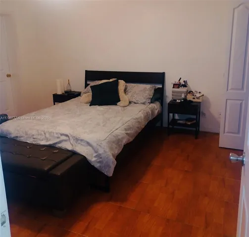 a bedroom with a bed and a night stand
