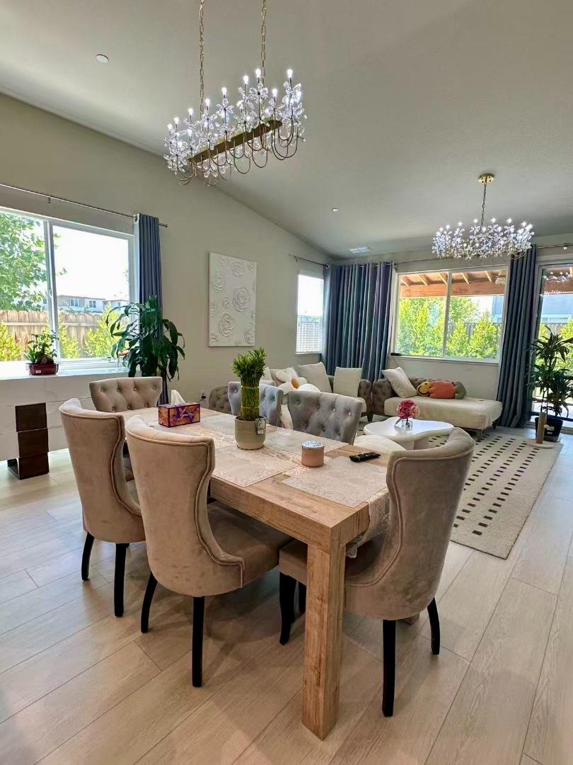 4341 Trailblazer Way Modesto, CA 95356 - Photo 10 of 27 a view of a dining room with furniture a livingroom and chandelier