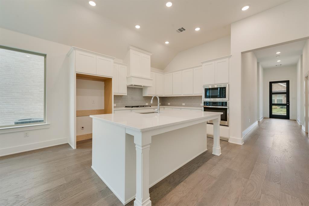 528 Embargo Drive Fate, TX 75189 - Photo 13 of 36 a kitchen with stainless steel appliances a white stove top oven and a refrigerator