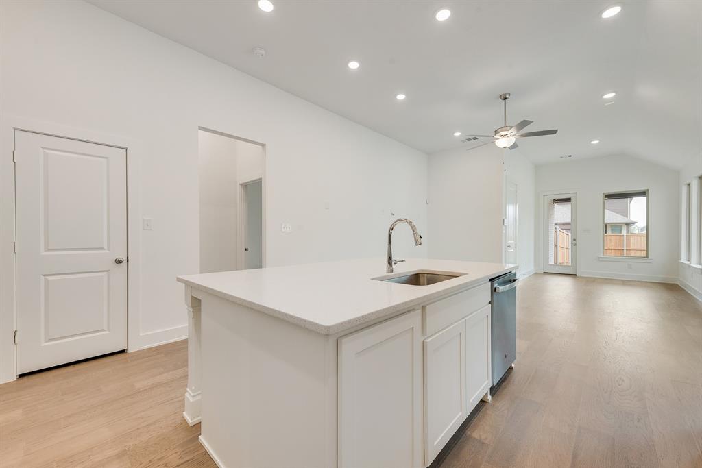 528 Embargo Drive Fate, TX 75189 - Photo 17 of 36 a view of a kitchen counter top a sink and dishwasher with wooden floor