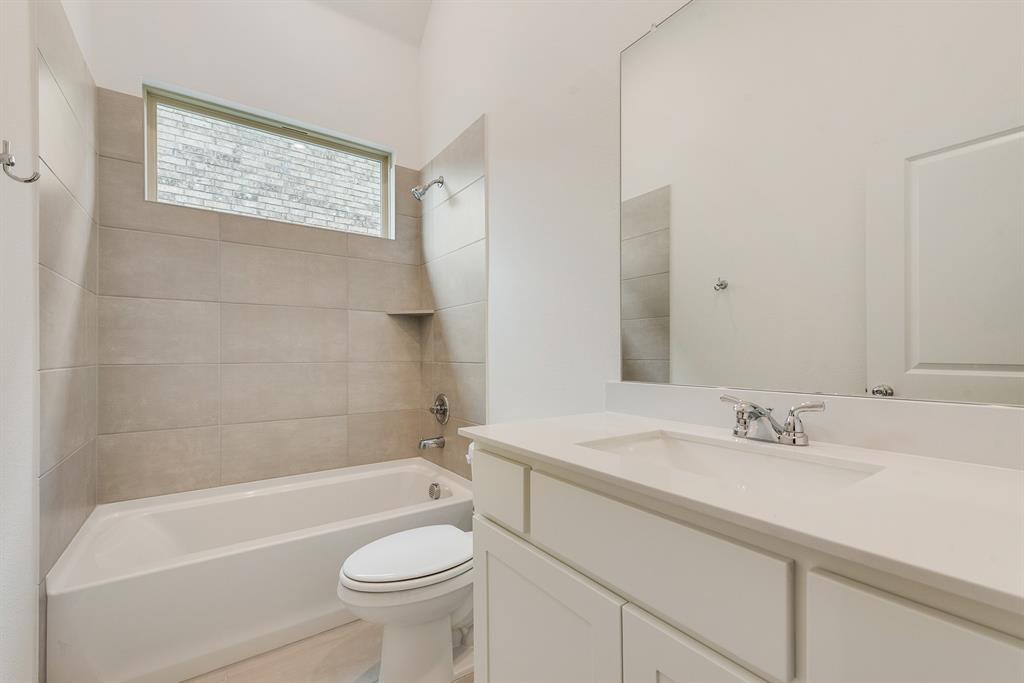 528 Embargo Drive Fate, TX 75189 - Photo 19 of 36 a bathroom with a sink a toilet and shower