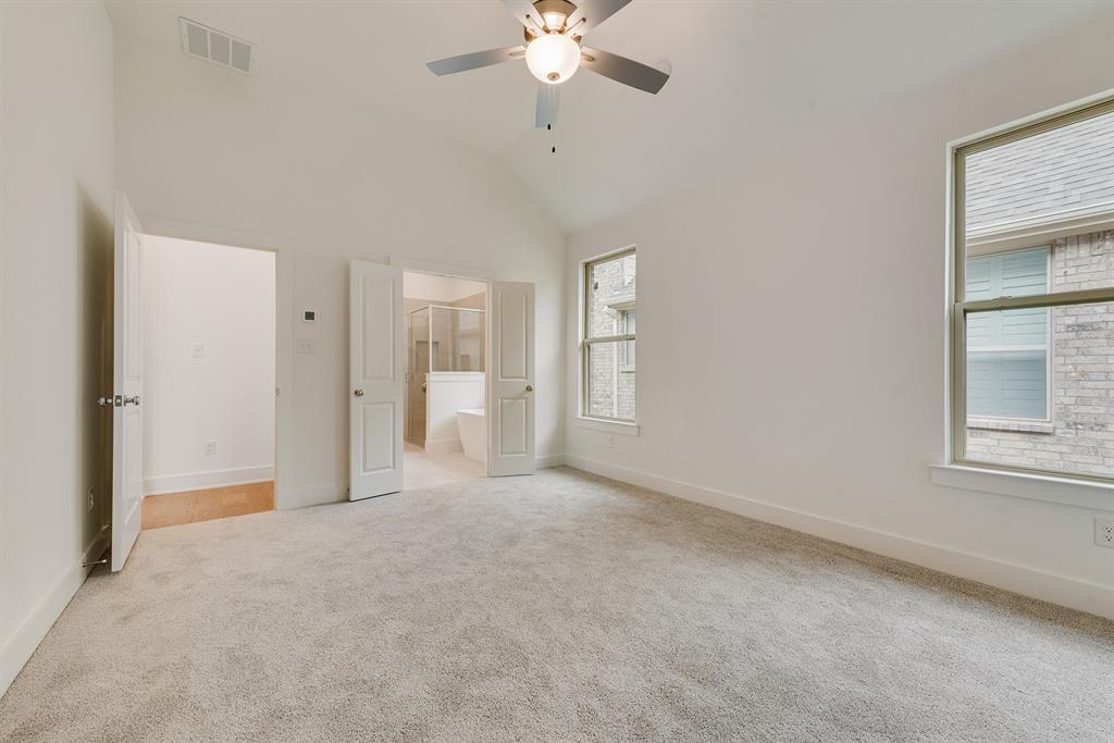 528 Embargo Drive Fate, TX 75189 - Photo 24 of 36 an empty room with chandelier fan and windows