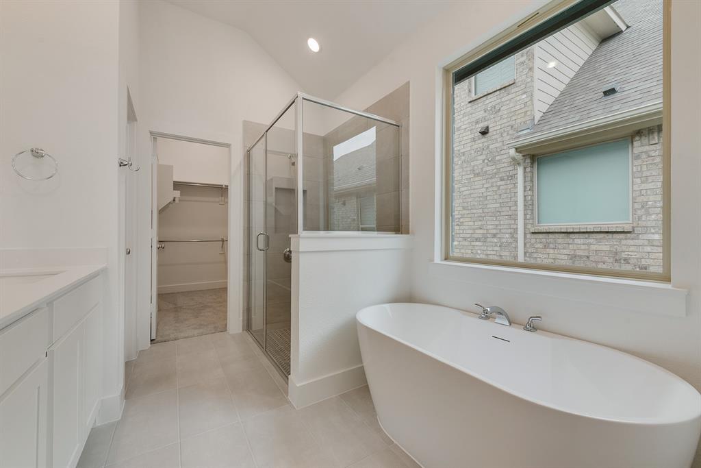 528 Embargo Drive Fate, TX 75189 - Photo 27 of 36 a bathroom with a bathtub and a shower