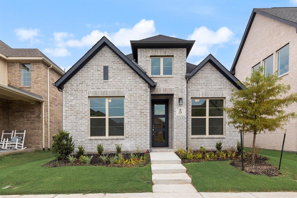 528 Embargo Drive Fate, TX 75189 - Photo 3 of 36 a front view of a house with a garden and trees