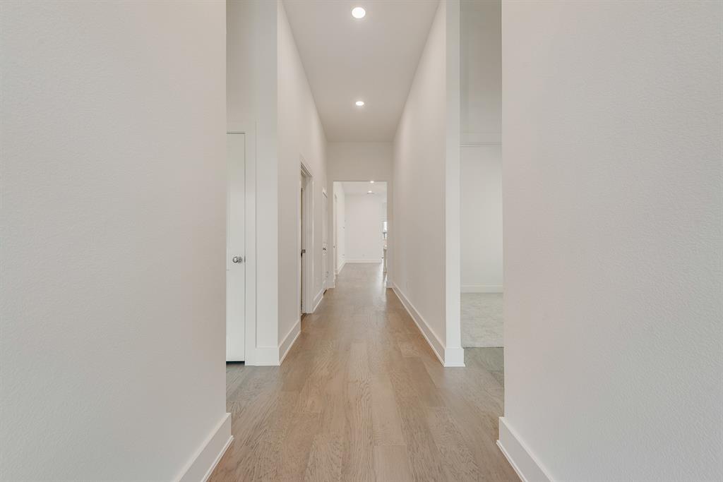528 Embargo Drive Fate, TX 75189 - Photo 6 of 36 a view of a hallway with wooden floor