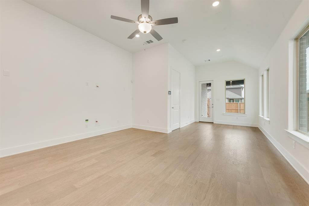 528 Embargo Drive Fate, TX 75189 - Photo 8 of 36 an empty room with chandelier fan and windows