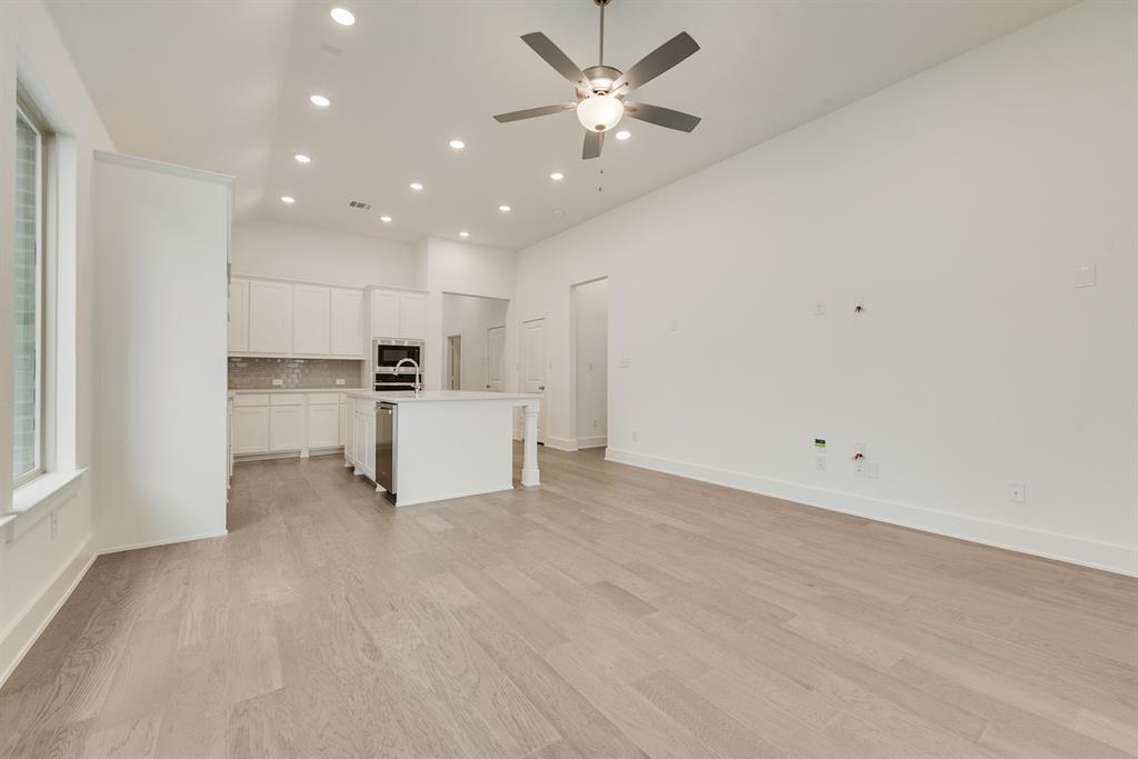 528 Embargo Drive Fate, TX 75189 - Photo 10 of 36 a view of a kitchen with a sink and a refrigerator