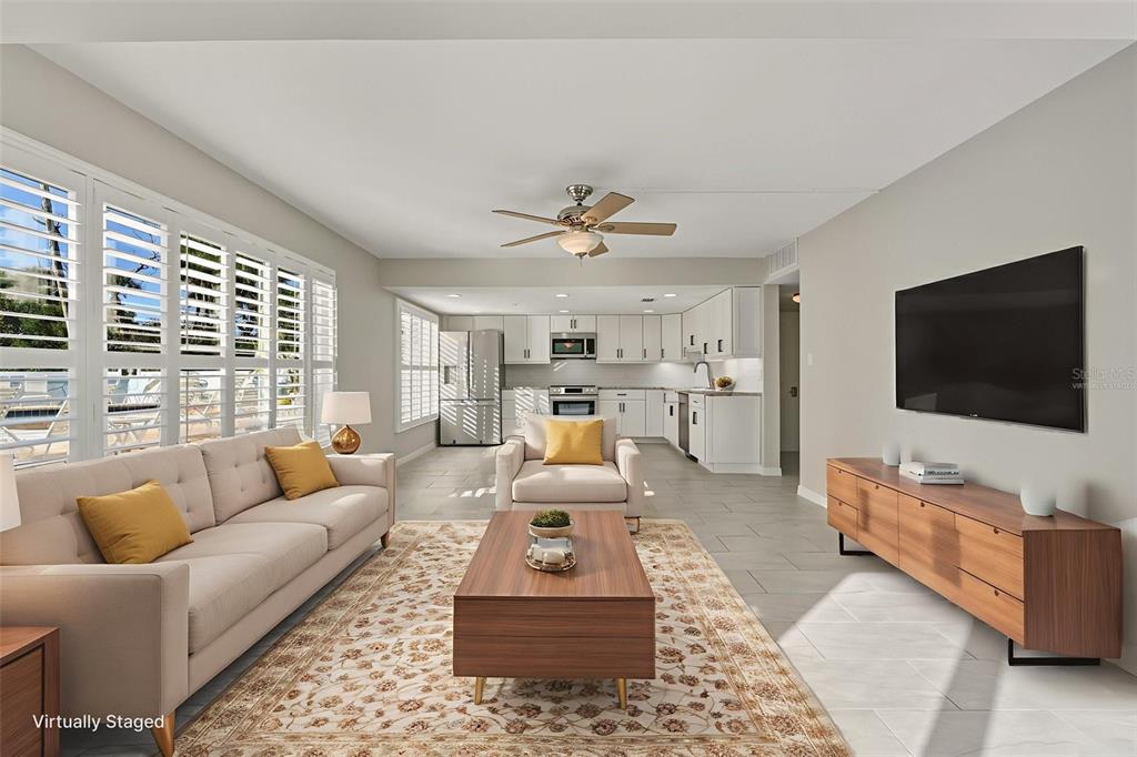 5055 North Beach Road, Unit 108 Englewood, FL 34223 - Photo 13 of 36 a living room with furniture and a flat screen tv