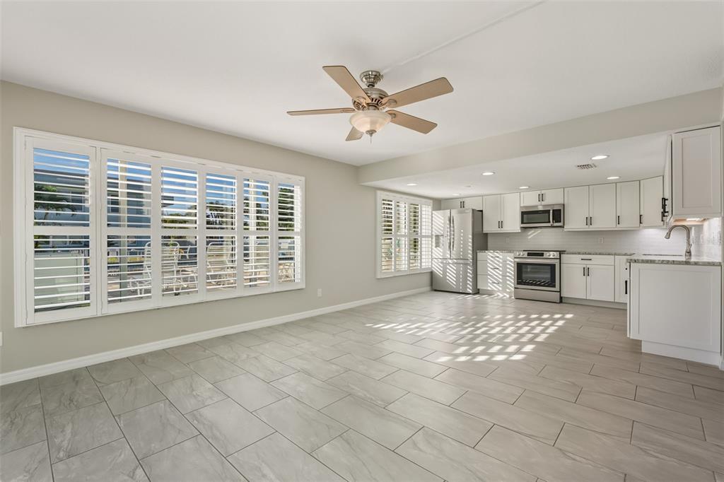 5055 North Beach Road, Unit 108 Englewood, FL 34223 - Photo 14 of 36 a view of an empty room with a kitchen