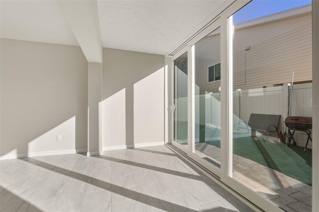 5055 North Beach Road, Unit 108 Englewood, FL 34223 - Photo 15 of 36 a view of a bedroom with floor to ceiling windows