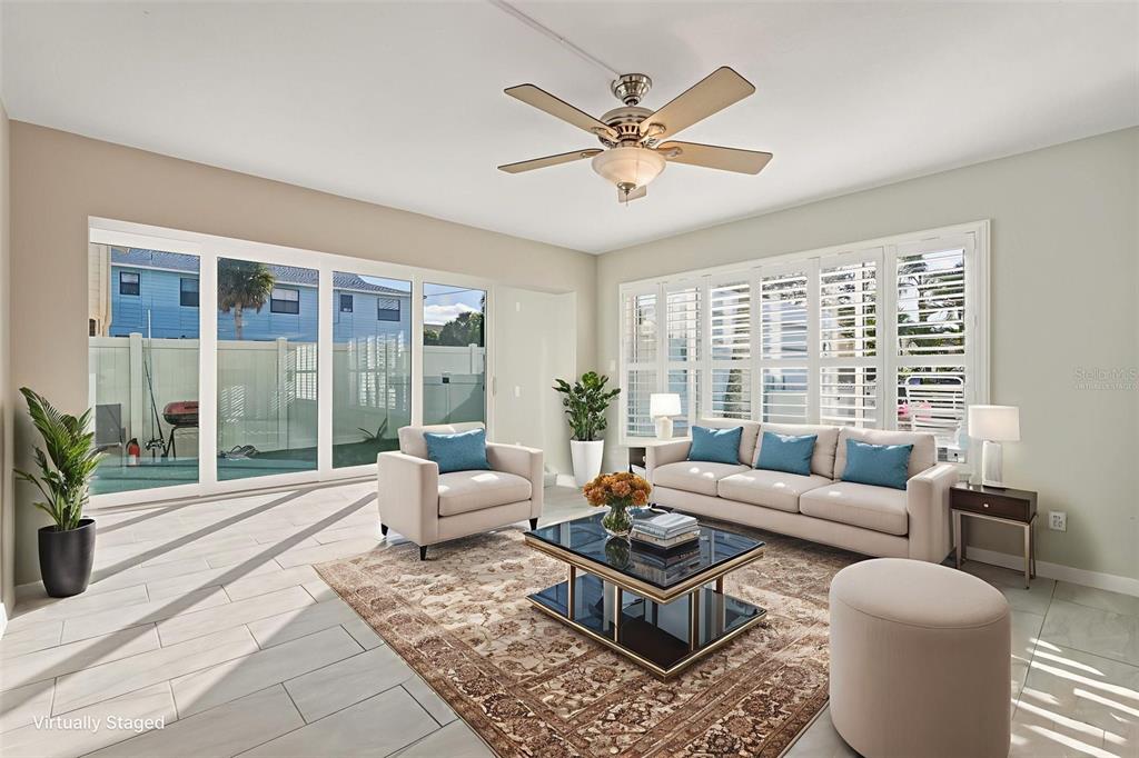 5055 North Beach Road, Unit 108 Englewood, FL 34223 - Photo 17 of 36 a living room with furniture and a large window