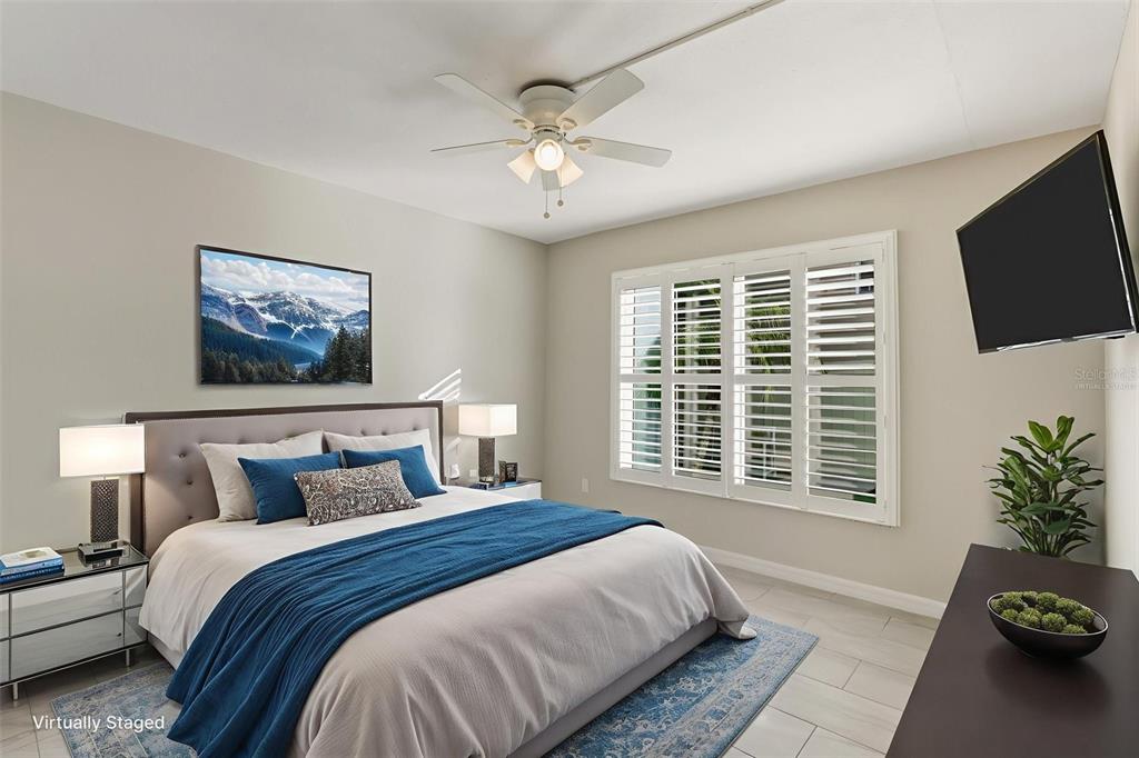 5055 North Beach Road, Unit 108 Englewood, FL 34223 - Photo 19 of 36 a bedroom with a large bed and a window