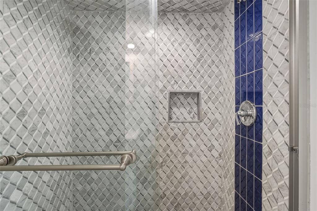 5055 North Beach Road, Unit 108 Englewood, FL 34223 - Photo 22 of 36 a bathroom with a shower curtain