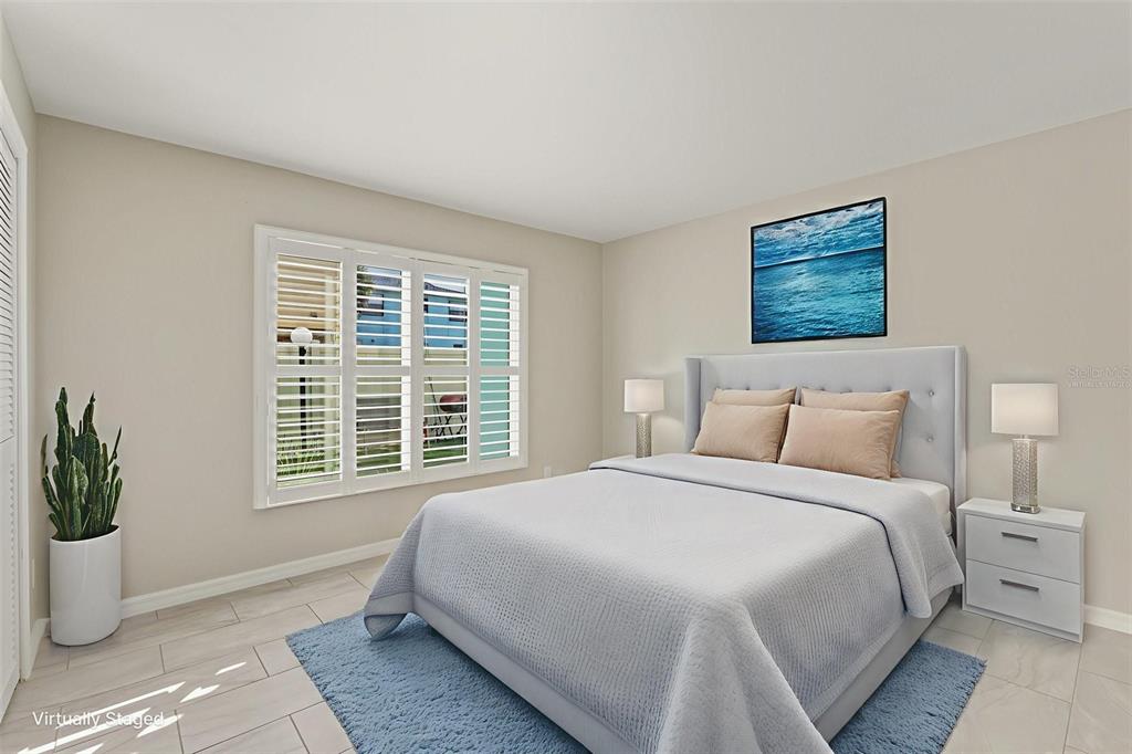 5055 North Beach Road, Unit 108 Englewood, FL 34223 - Photo 23 of 36 a bedroom with a large bed and a window