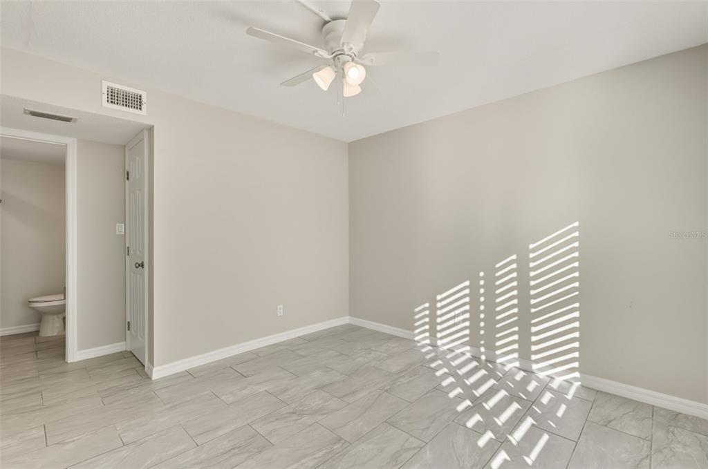 5055 North Beach Road, Unit 108 Englewood, FL 34223 - Photo 24 of 36 a view of room with stairs and a ceiling fan