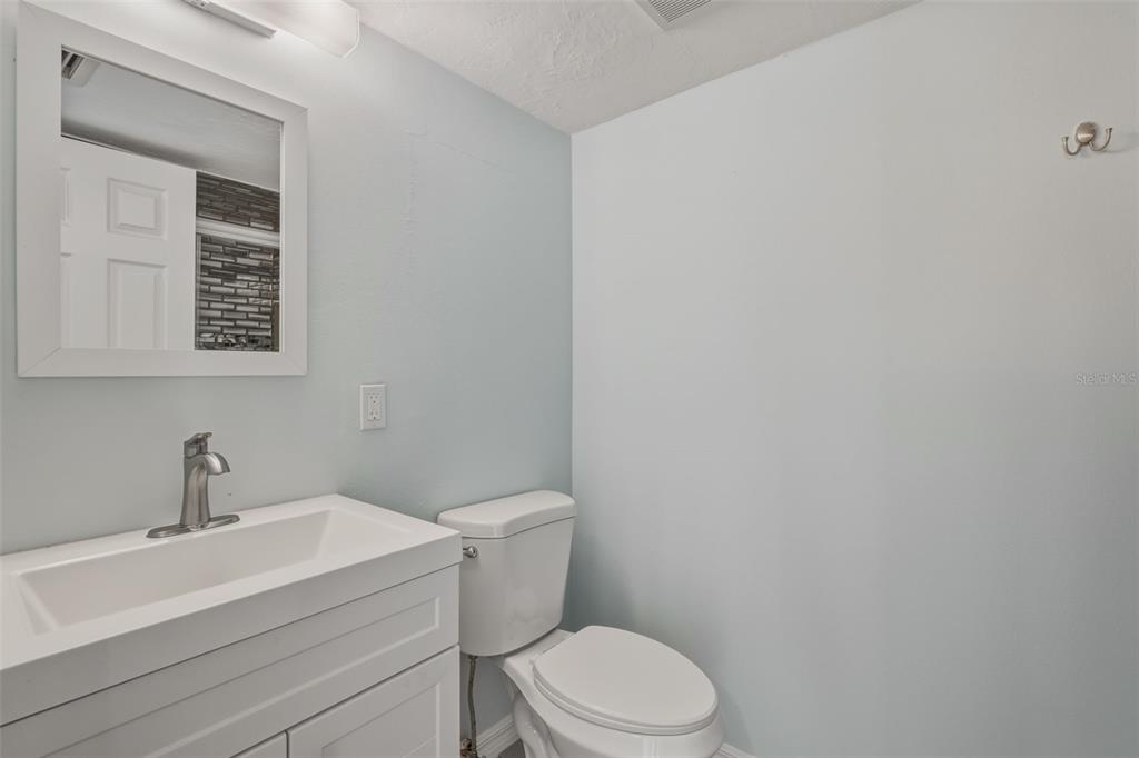 5055 North Beach Road, Unit 108 Englewood, FL 34223 - Photo 26 of 36 a white toilet sitting next to a bathroom sink
