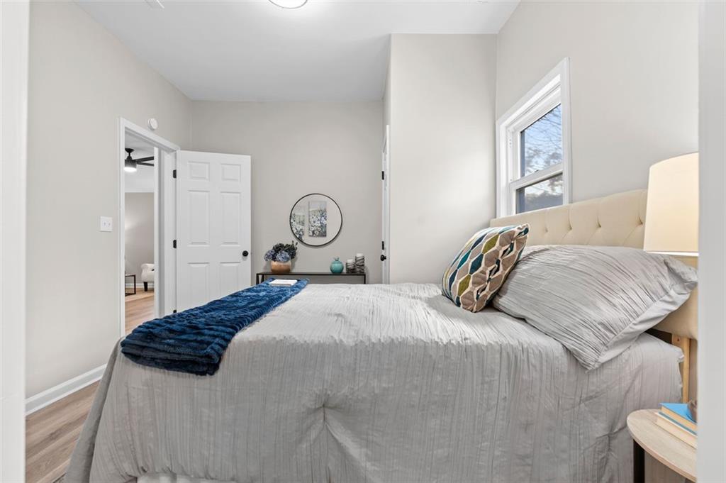 118 Perry Street Monroe, GA 30655 - Photo 18 of 30 a bedroom with a bed and painting on the wall