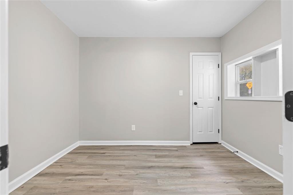 118 Perry Street Monroe, GA 30655 - Photo 20 of 30 a view of empty room with wooden floor