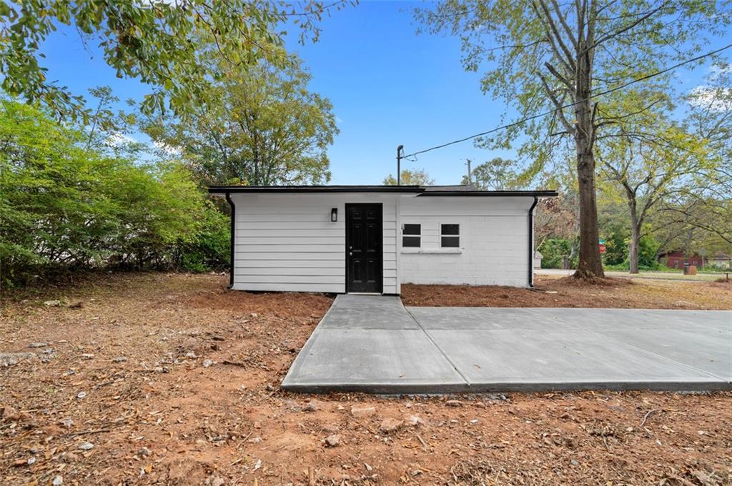 118 Perry Street Monroe, GA 30655 - Photo 23 of 30 a front view of a house with a yard and garage