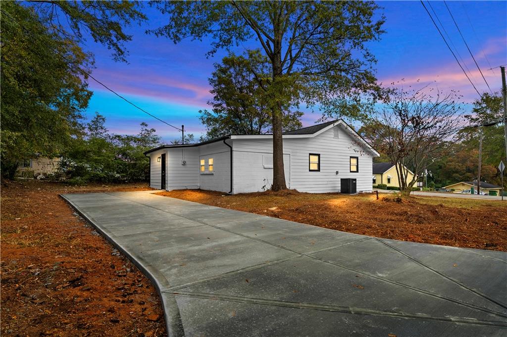 118 Perry Street Monroe, GA 30655 - Photo 25 of 30 a front view of a house with a yard and garage