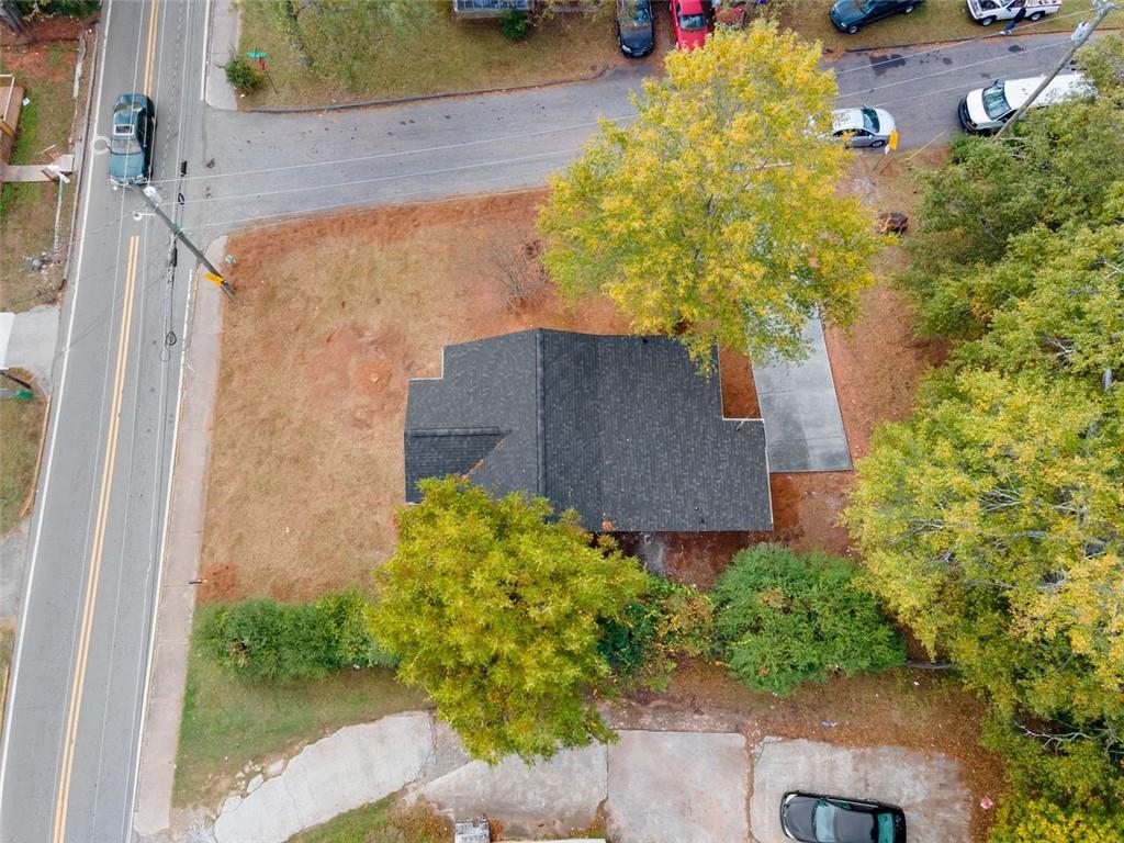 118 Perry Street Monroe, GA 30655 - Photo 27 of 30 front view of a house with a yard and potted plants
