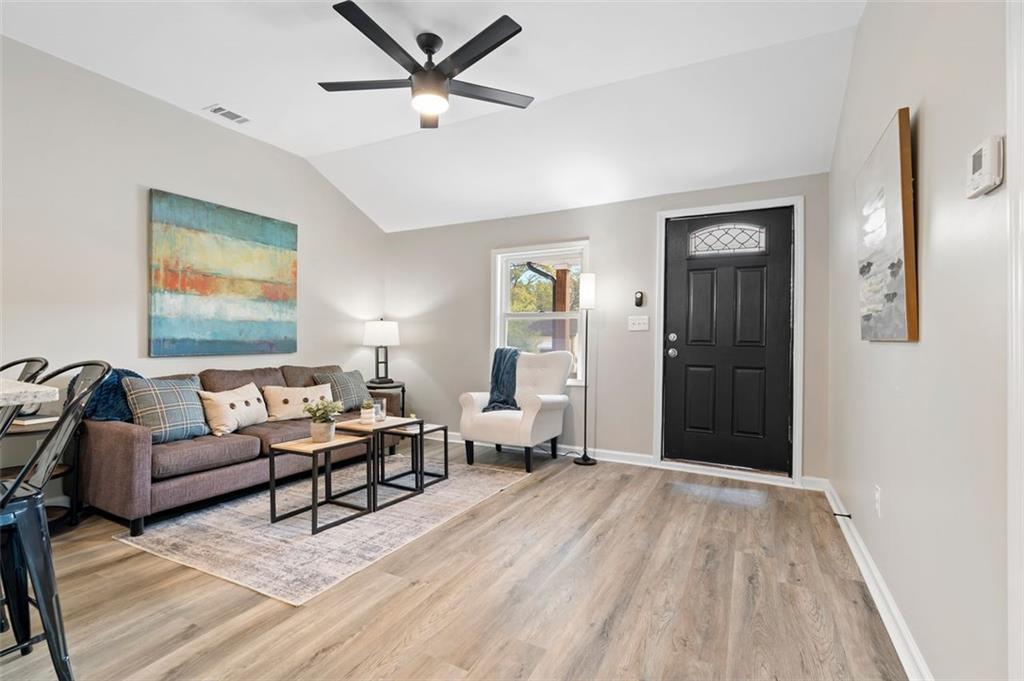118 Perry Street Monroe, GA 30655 - Photo 4 of 30 a living room with furniture and a wooden floor
