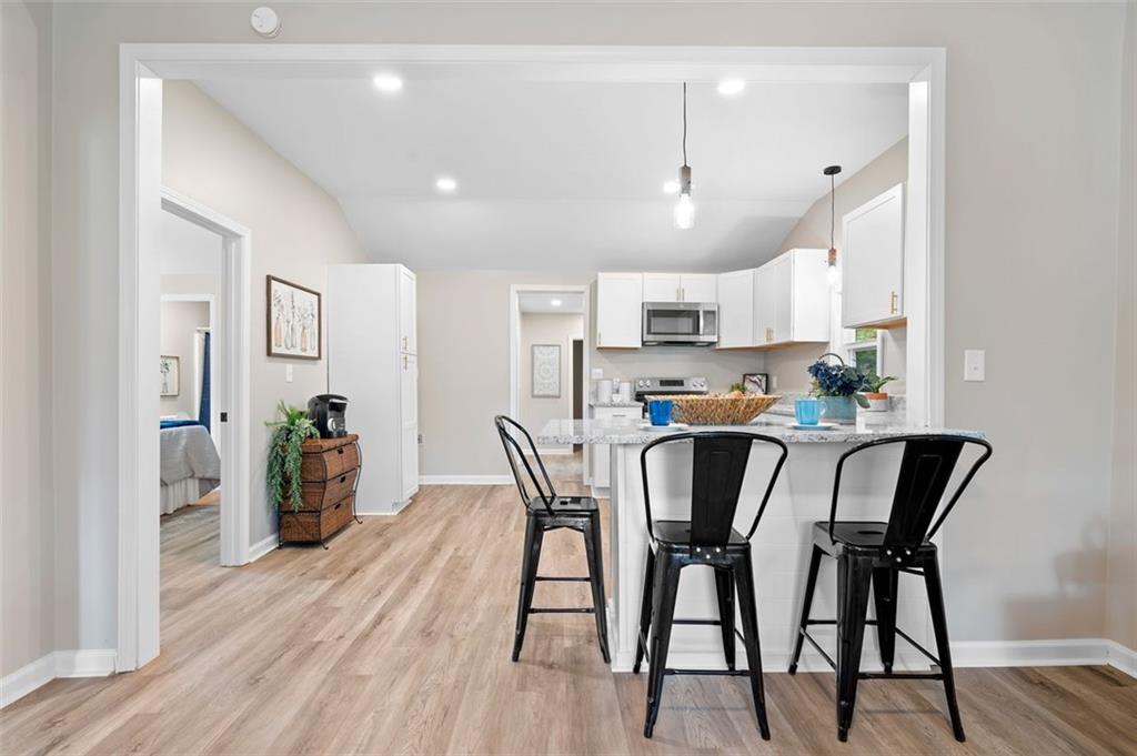 118 Perry Street Monroe, GA 30655 - Photo 7 of 30 a view of a dining room with furniture and wooden floor