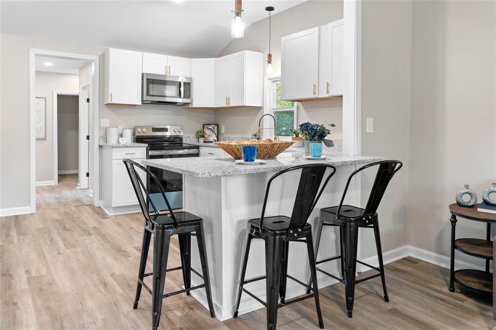 118 Perry Street Monroe, GA 30655 - Photo 8 of 30 a view of a dining room with furniture and wooden floor