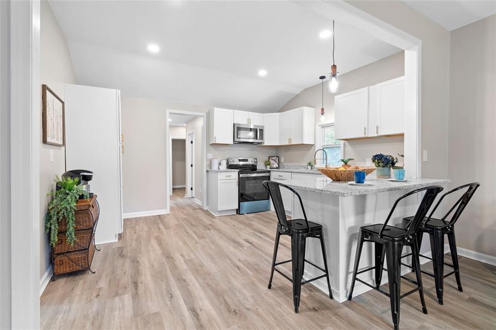 118 Perry Street Monroe, GA 30655 - Photo 9 of 30 a view of kitchen with cabinets and wooden floor