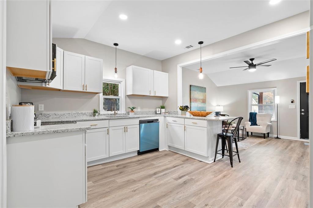 118 Perry Street Monroe, GA 30655 - Photo 10 of 30 a kitchen with a sink cabinets and wooden floor