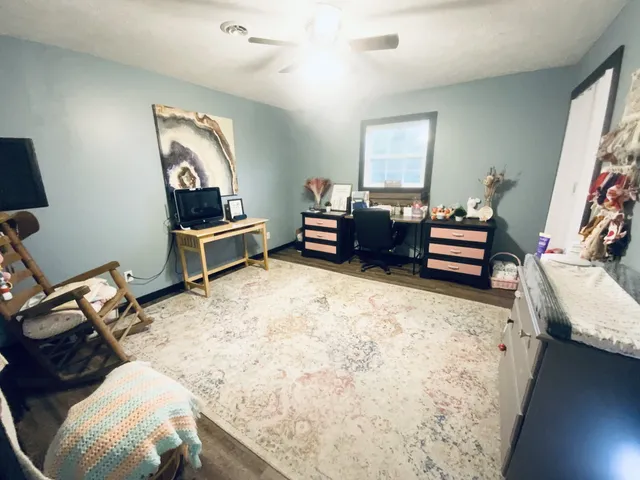 a bedroom with furniture and a window