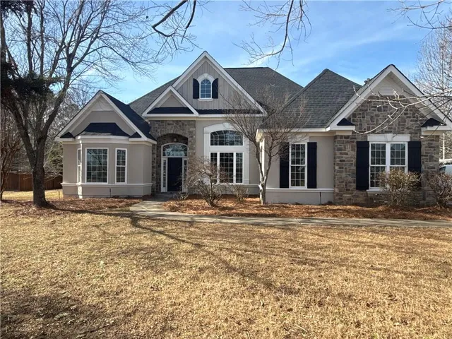 a front view of a house with a garden