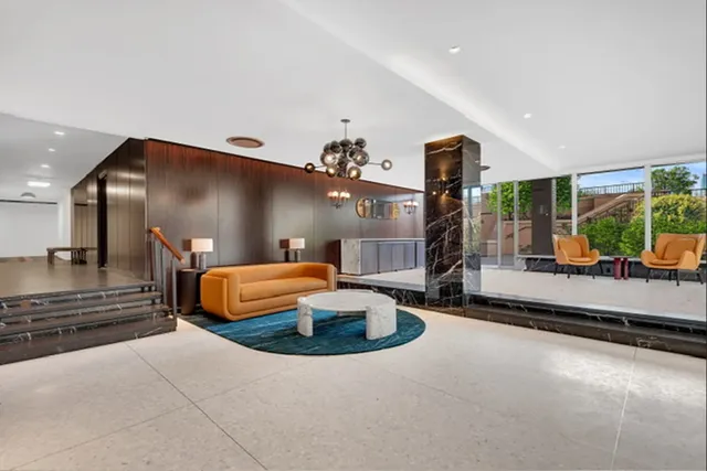 a living room with furniture a garden and a large window